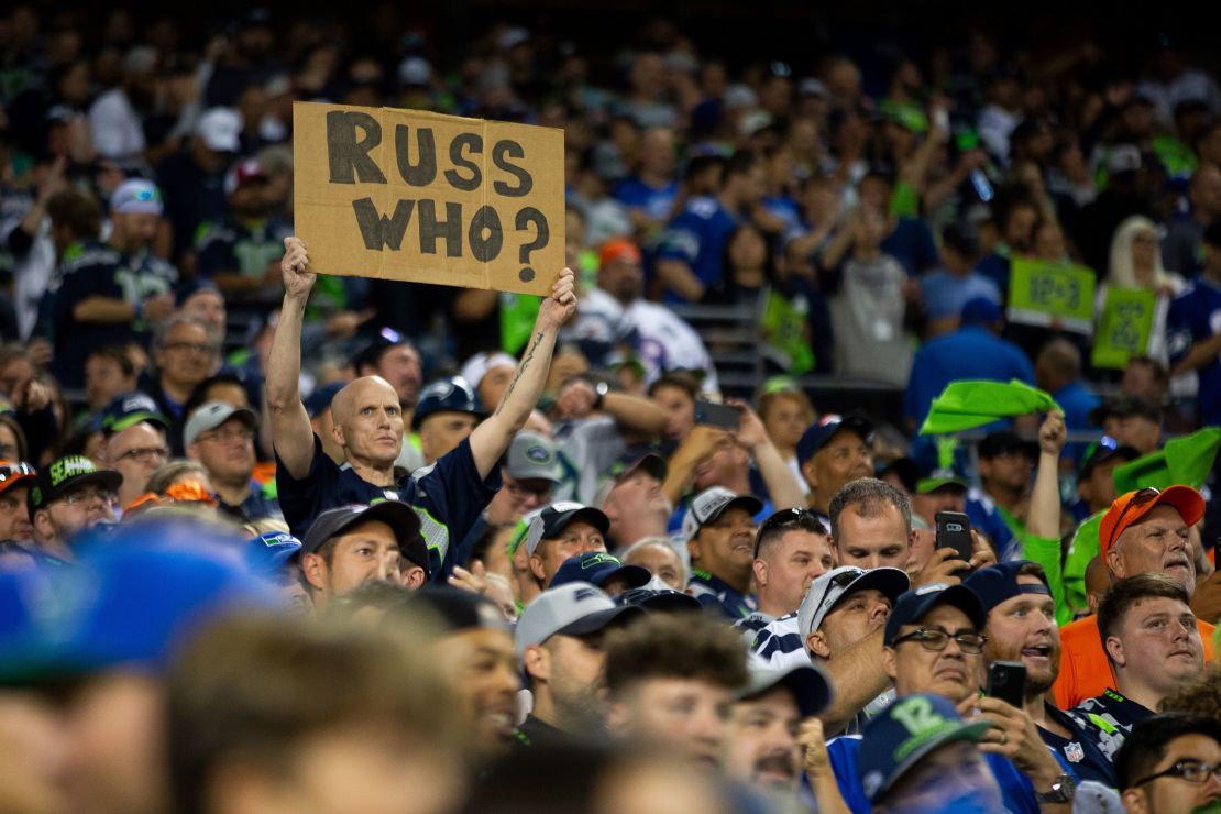 A Seattle Seahawks fan holds a sign referencing Wilson during the second half. 