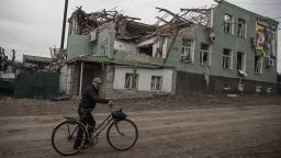 KHARKIV, UKRAINE - SEPTEMBER 11: A man pushes his bicycle in front of buildings, damaged in the conflicts between Russian and Ukrainian forces, as seen after Ukrainian army liberated the town of Balakliya in the southeastern Kharkiv oblast, Ukraine, on September 11, 2022. (Photo by Metin Aktas/Anadolu Agency via Getty Images)