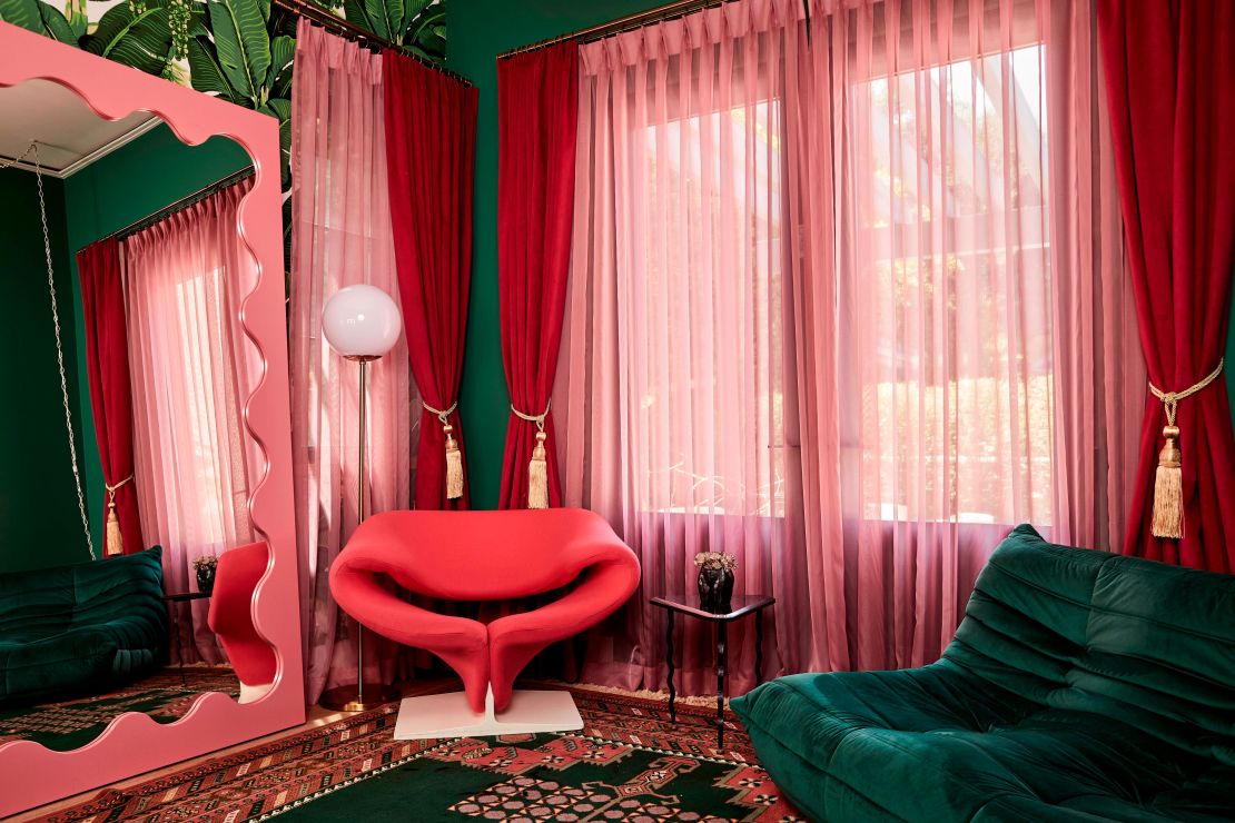 The "glam room" has a bold pink and green color scheme.