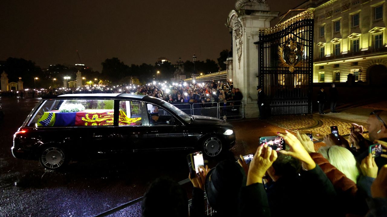 People watch the hearse carrying the coffin of Britain's Queen Elizabeth, following her death, in London on September 13.