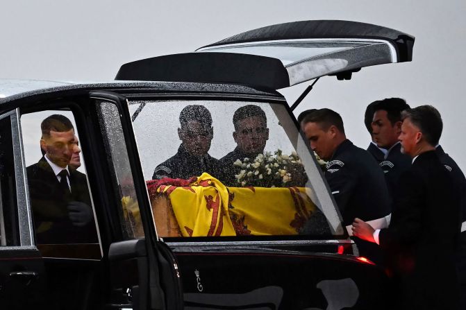 Pallbearers place the Queen's coffin into the hearse after it arrived in England on Tuesday.