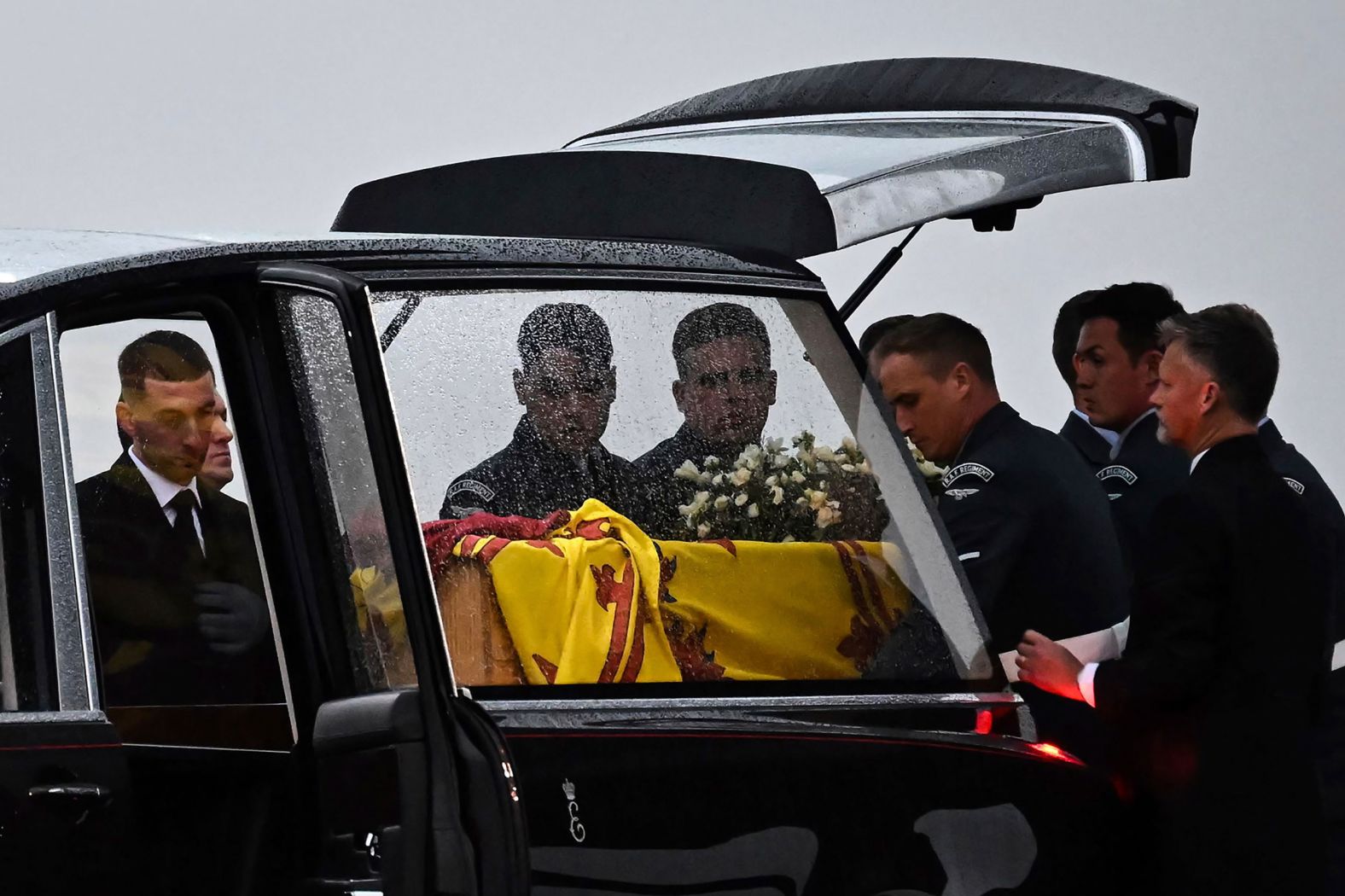 Pallbearers place the Queen's coffin into the hearse after it arrived in England on Tuesday.