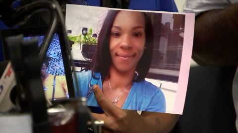A family member holds an image of Tiffany Fletcher at Monday's news conference.