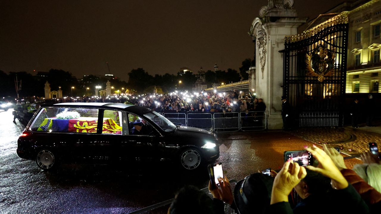 The hearse carrying the Queen's coffin arrives at Buckingham Palace on Tuesday evening. 