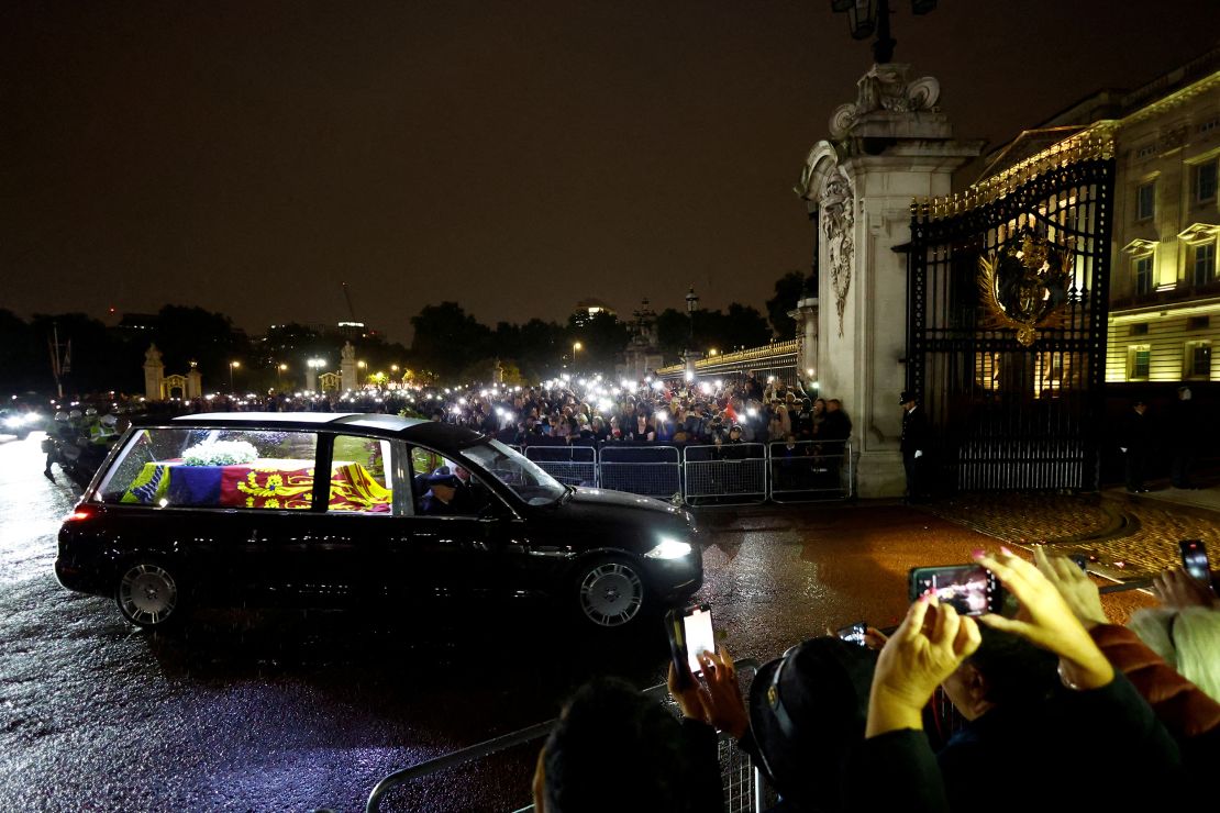 The hearse carrying the Queen's coffin arrives at Buckingham Palace on Tuesday evening. 