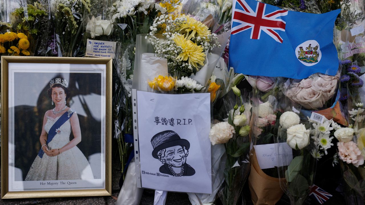 Mourners placed  colonial flags and images of the Queen outside the British consulate in Hong Kong on September 12, 2022. 