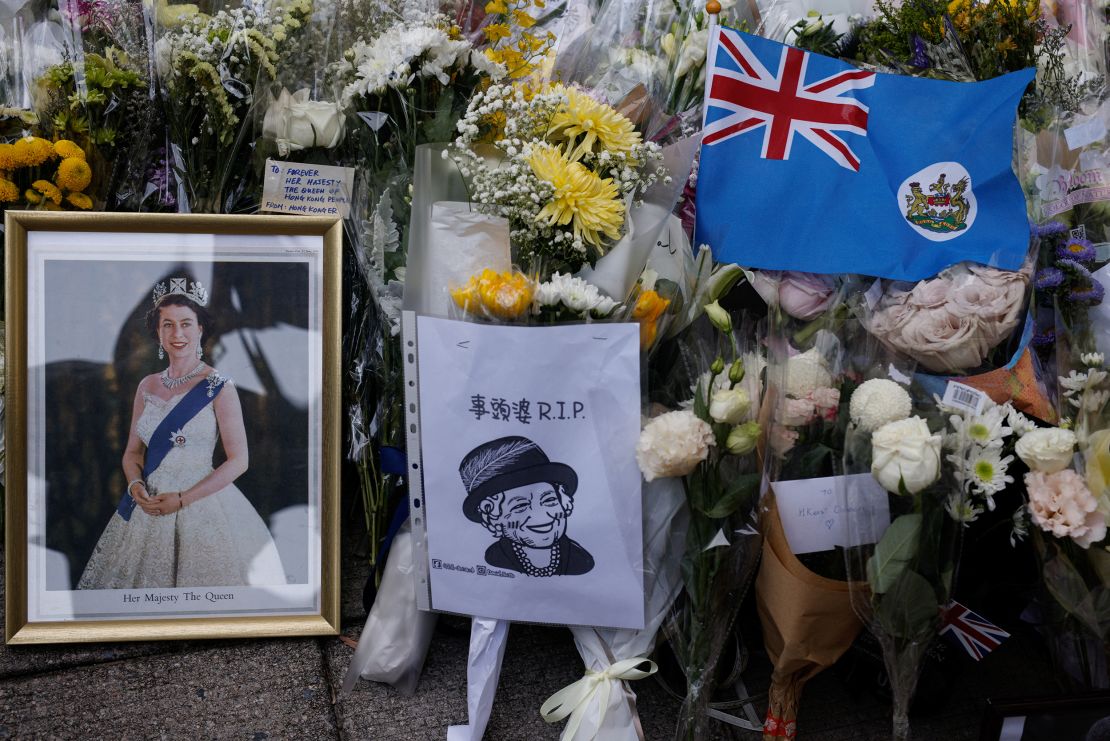 Mourners placed  colonial flags and images of the Queen outside the British consulate in Hong Kong on September 12, 2022. 