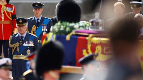 Britain's King Charles and his son, Prince William, march behind the Queen's coffin as it travels from Buckingham Palace to the Houses of Parliament for her lying in state.