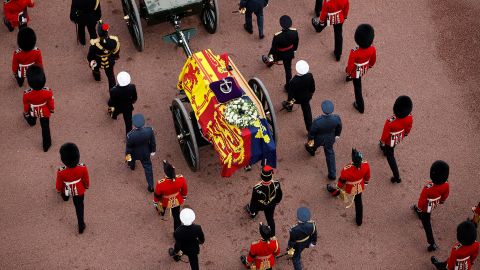 Queen Elizabeth II's flag-draped coffin is taken in procession on a gun garriage of The King's Troop Royal Horse Artillery from Buckingham Palace to Westminster Hall on September 14, 2022.