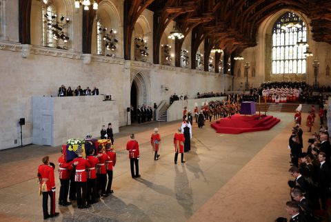 The Queen's coffin is carried into Westminster Hall.