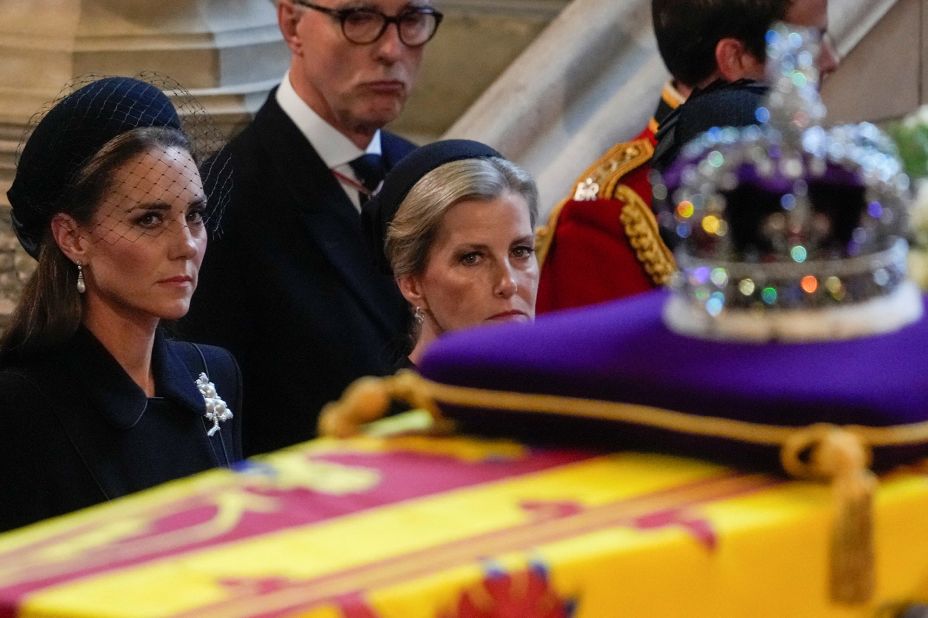 Catherine, the Princess of Wales, and Sophie, the Countess of Wessex, watch the Queen's coffin arrive at Westminster Hall on Wednesday. The coffin was adorned with the Imperial State Crown.