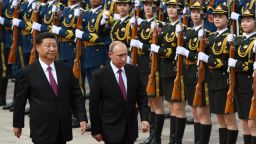 TOPSHOT - Russia's President Vladimir Putin (C) reviews a military honour guard with Chinese President Xi Jinping (L) during a welcoming ceremony outside the Great Hall of the People in Beijing on June 8, 2018. - Putin arrived on June 8 for a state visit to China and will attend the Shanghai Cooperation Organisation Leaders Summit in the eastern port city of Qingdao on June 9-10. (Photo by Greg BAKER / POOL / AFP) (Photo by GREG BAKER/POOL/AFP via Getty Images)