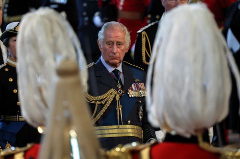 The King watches his mother's coffin arrive at Westminster Hall.