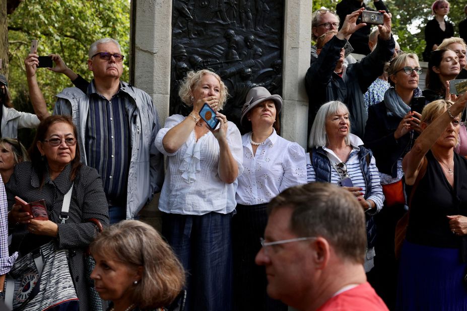People watch as the Queen's coffin passes them on Wednesday.