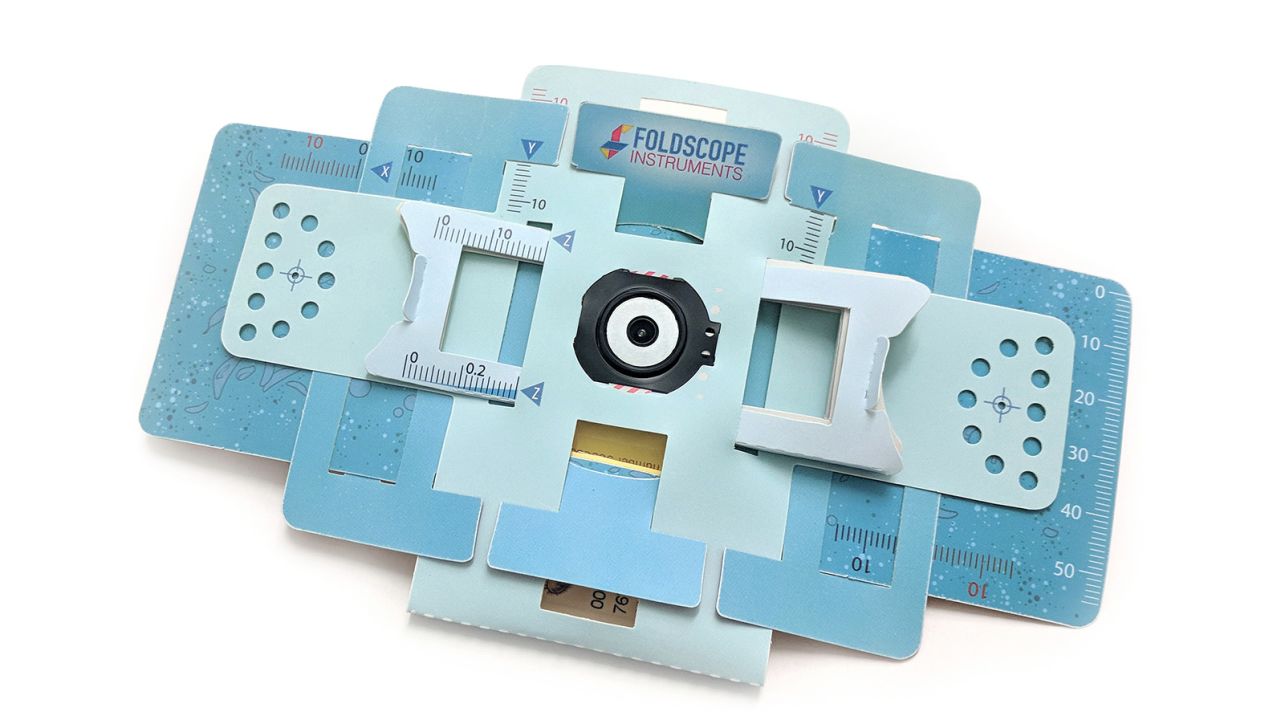 A Foldscope, a powerful microscope made from paper, is shown.