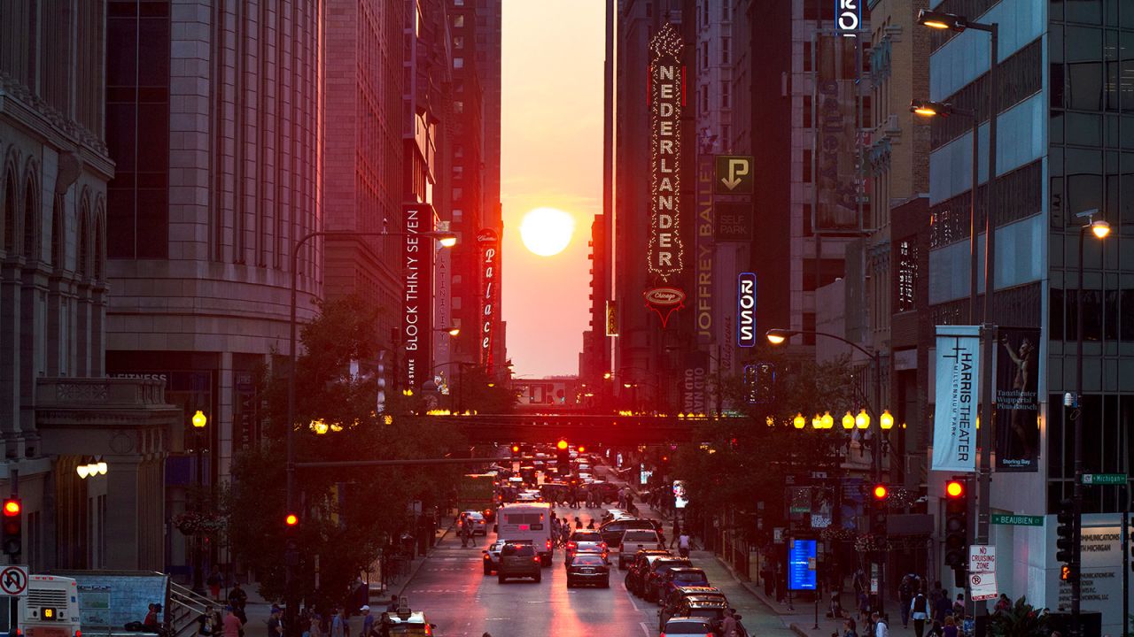 The setting sun is seen looking west on Randolph Street in Chicago just days before the autumnal equinox in 2019. 