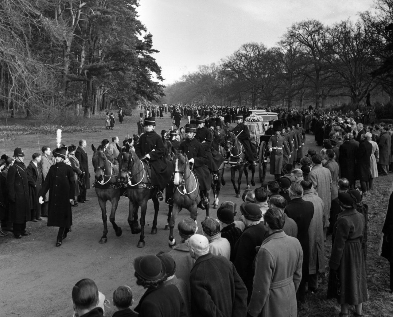 A gun carriage carrying the King's coffin makes its way from Sandringham to Wolferton station in Norfolk, England, before being transported to London on February 11, 1952.