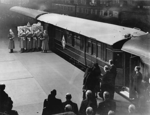 The coffin is taken from a train at King's Cross Station in London on its way to Westminster Hall, where the King would lie in state until his funeral.