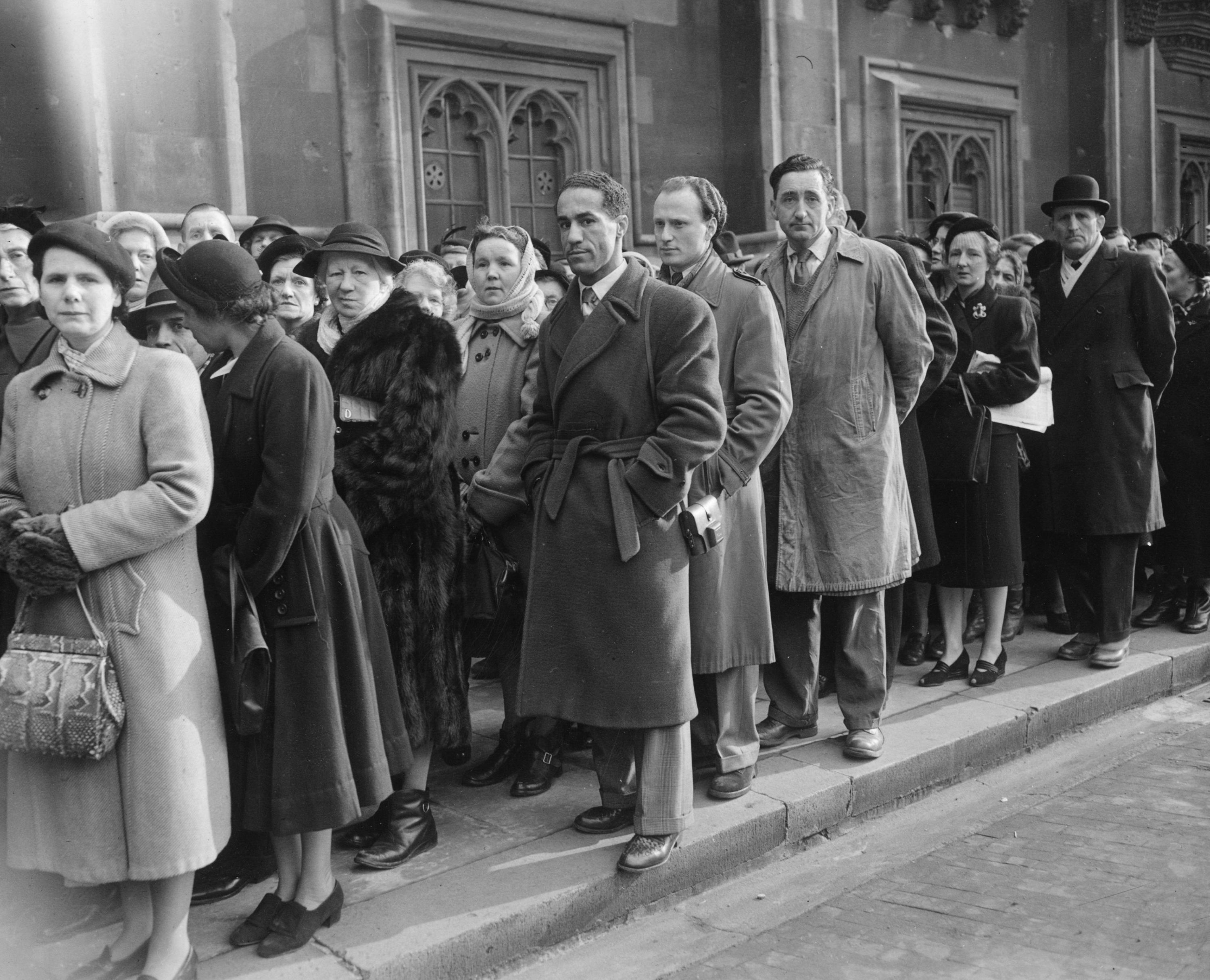 British boxer Alex Buxton, center, is among the mourners waiting in line to pay their respects to the King in Westminster Hall.