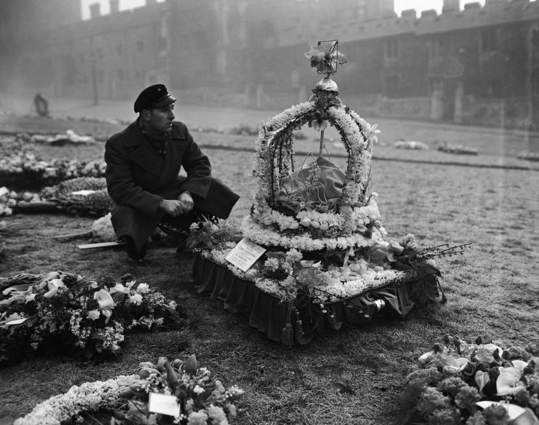 A man views one of the many wreaths laid out at the grounds of Windsor Castle for the funeral. The tribute in the shape of a large crown was from the mayor and people of Swansea, Wales.