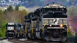 A Norfolk Southern freight train passes a train on a siding as it approaches a crossing in Homestead, Pa, Wednesday, April 27, 2022. 
