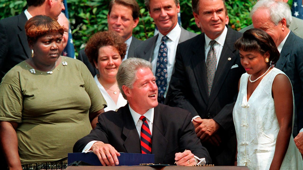 Then-President Bill Clinton prepares to sign legislation in the Rose Garden of the White House overhauling America's welfare system in August 1996. 