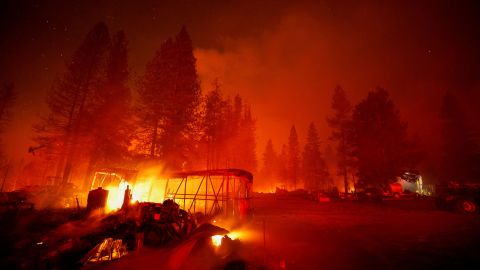 Structures burn Tuesday in the Mosquito Fire in Foresthill, California.