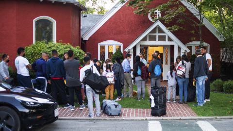 Immigrants gather with their belongings outside St. Andrews Episcopal Church on Wednesday September 14, 2022, in Edgartown, Massachusetts, on Martha's Vineyard. 