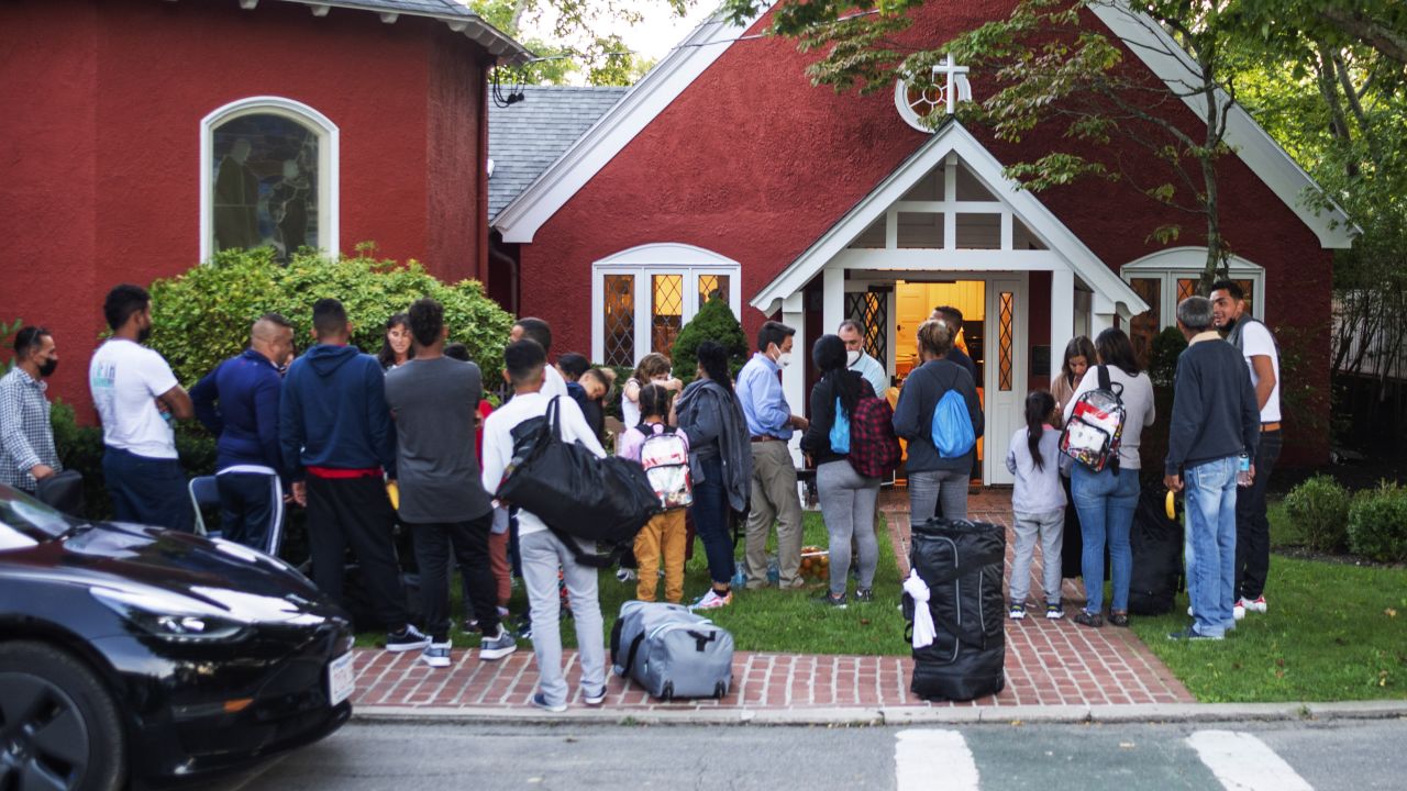 Immigrants gather with their belongings outside St. Andrews Episcopal Church, Wednesday Sept. 14, 2022, in Edgartown, Mass., on Martha's Vineyard. Florida Gov. Ron DeSantis on Wednesday flew two planes of immigrants to Martha's Vineyard, escalating a tactic by Republican governors to draw attention to what they consider to be the Biden administration's failed border policies. (Ray Ewing/Vineyard Gazette via AP)