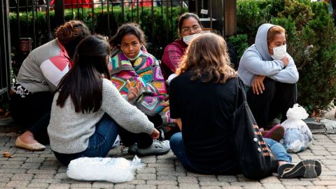 Migrants from Central and South America wait near the residence of Vice President Kamala Harris after being dropped off on September 15, 2022, in Washington, DC.