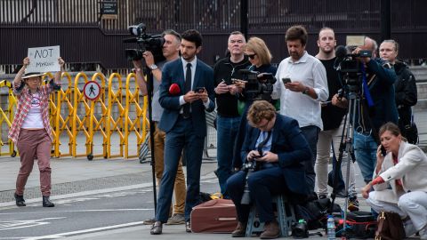 An anti-monarchy protester approaches the media outside the Houses of Parliament on Monday.