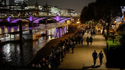 People stand in line along Southbank, forming a queue to pay their respects to the Queen.