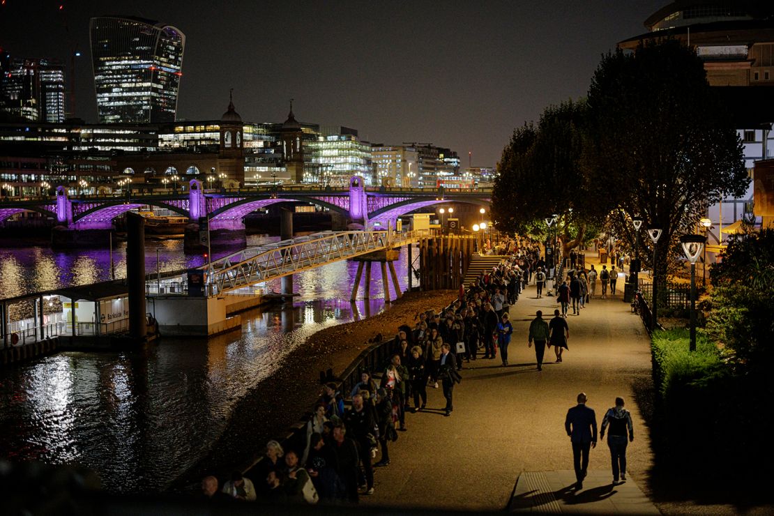 People stand in line along Southbank, forming a queue to pay their respects to the Queen.