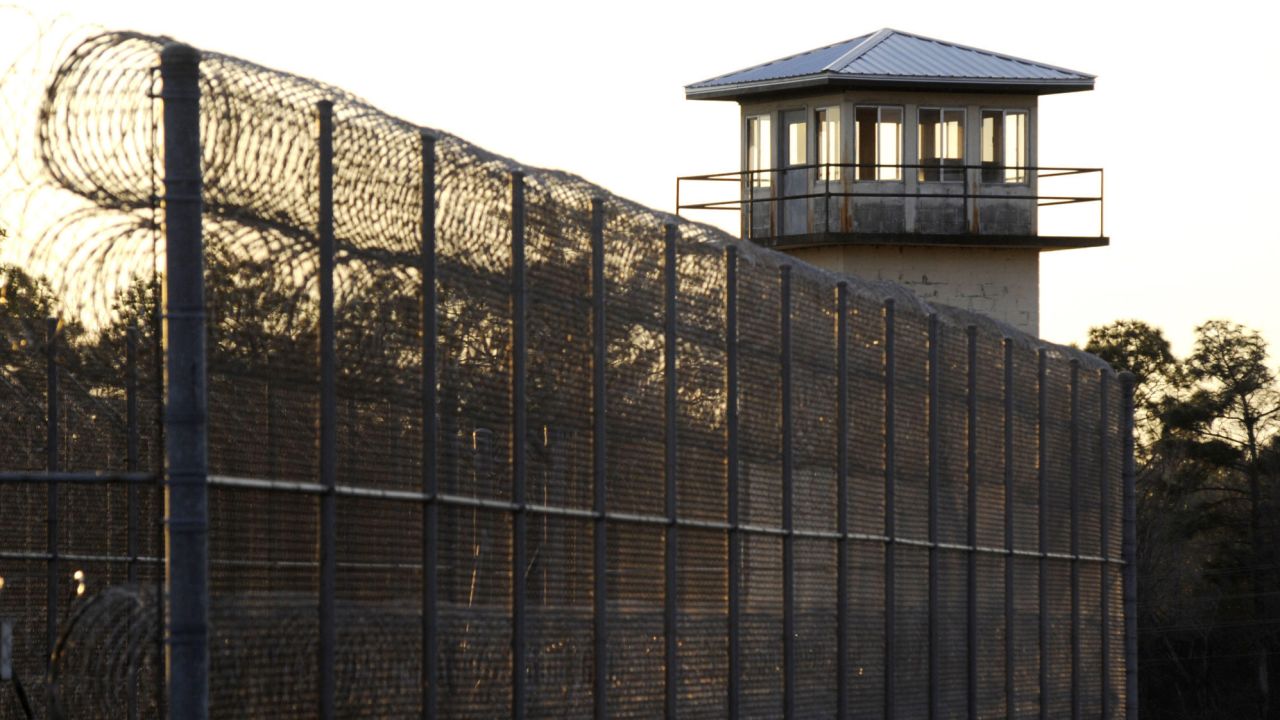 The sun sets in January behind Holman Correctional Facility, home to Alabama's death row.