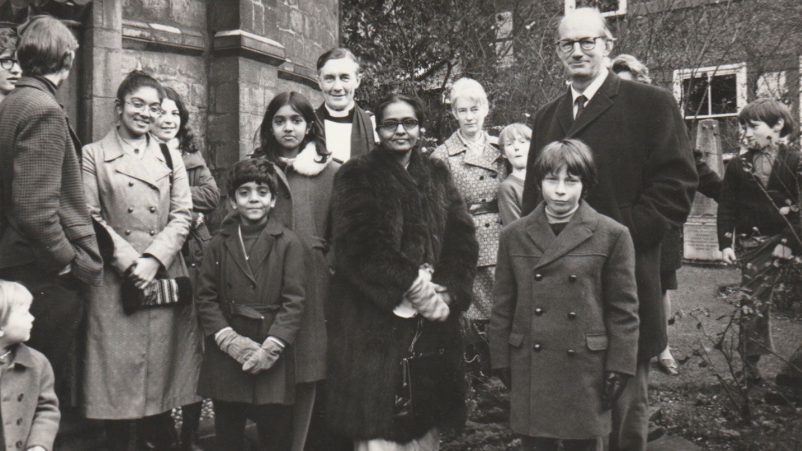 The writer's family outside a church in Cambridge, UK, after leaving Uganda in 1972. Lucy's grandmother Rachel, center, wears a donated fur coat. 
