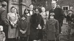 The writer's family outside a church in Cambridge, UK, after leaving Uganda in 1972. Lucy's grandmother Rachel, center, wears a donated fur coat, and mother Betty is pictured far left.