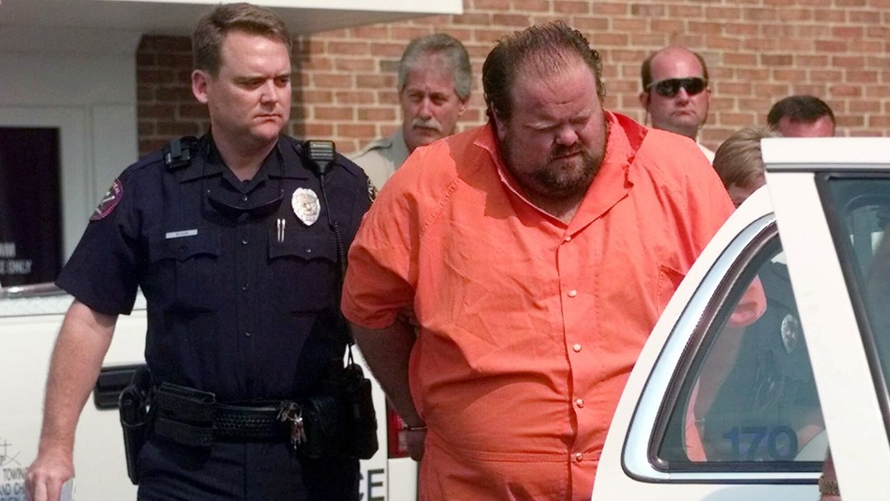 Officials escort Alan Eugene Miller in 1999 from the Pelham City Jail in Alabama.