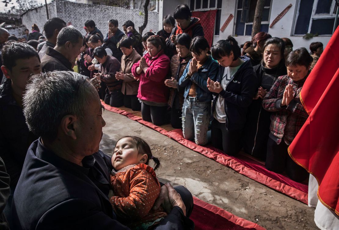 Chinese Christians wait to take communion at the Palm Sunday Mass during the Easter Holy Week at an underground or unofficial church  in China.