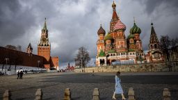 A woman walks outside the Kremlin, Red Square and St. Basil's Cathedral in central Moscow on February 22, 2022. - Russian President Vladimir Putin said on February 22 that he does not plan to restore Russia's empire, a day after he ordered Russian troops to be sent to eastern Ukraine and questioned Ukraine's sovereignty. (Photo by Dimitar DILKOFF / AFP) (Photo by DIMITAR DILKOFF/AFP via Getty Images)