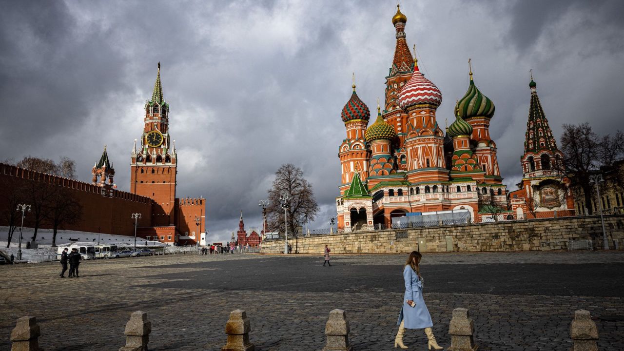 A woman walks outside the Kremlin, Red Square and St. Basil's Cathedral in central Moscow on February 22, 2022.
