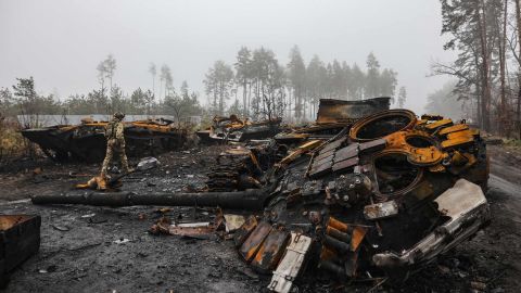 An Ukranian soldier walks near destroyed Russian tanks, in the outskirts of Kyiv, on April 1, 2022.