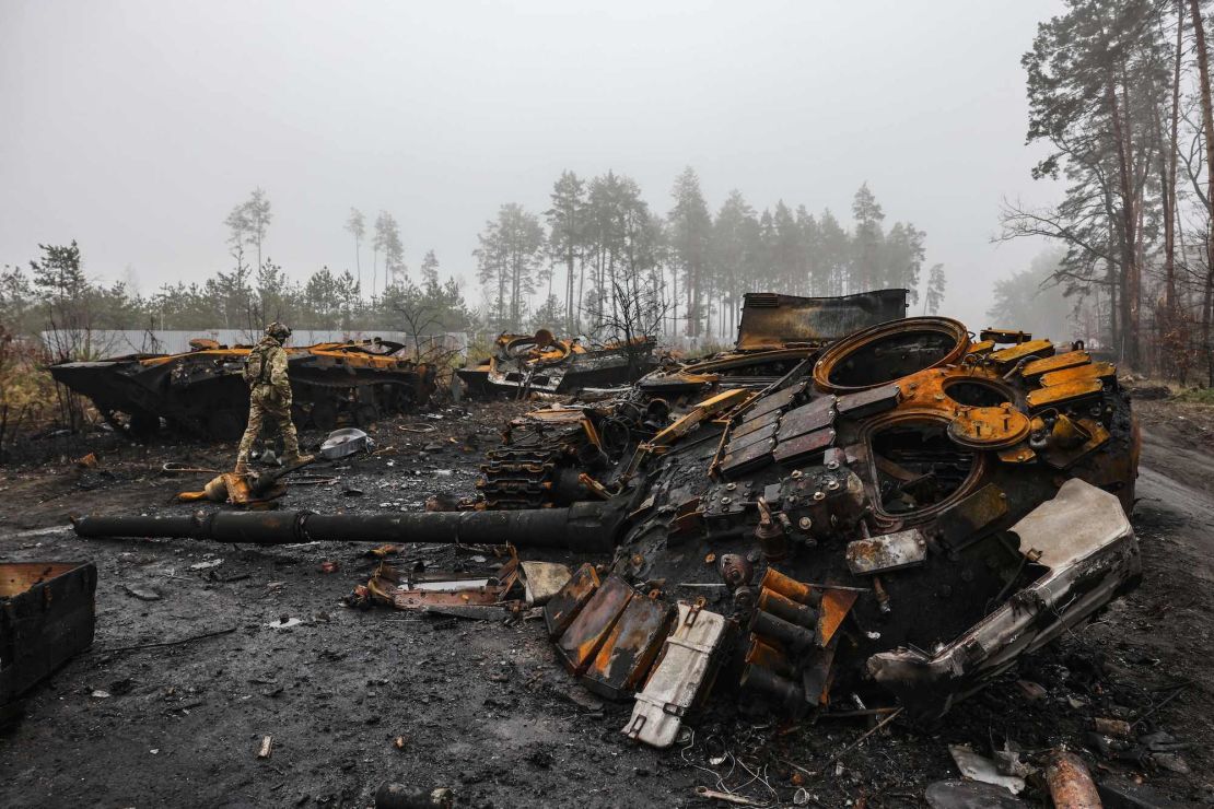 An Ukranian soldier walks near destroyed Russian tanks, in the outskirts of Kyiv, on April 1, 2022.