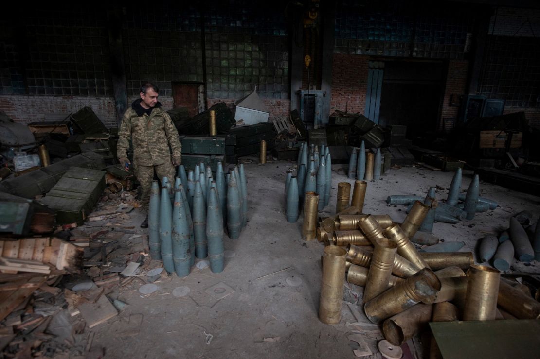 A Ukrainian service member checks Russia artillery shells captured during a counteroffensive operation near the town of Izium on September 14, 2022. 