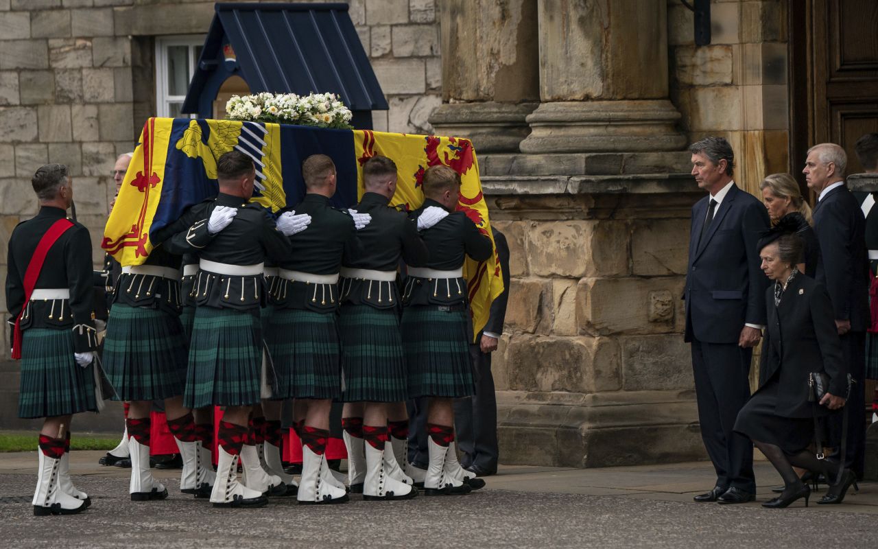 Britain's Princess Anne curtseys as the coffin of her mother, Queen Elizabeth II, enters the Palace of Holyroodhouse in Edinburgh, Scotland on Sunday, September 11. Thousands lined the route of the royal cortege that passed through the Scottish countryside and the cities of Aberdeen and Dundee.