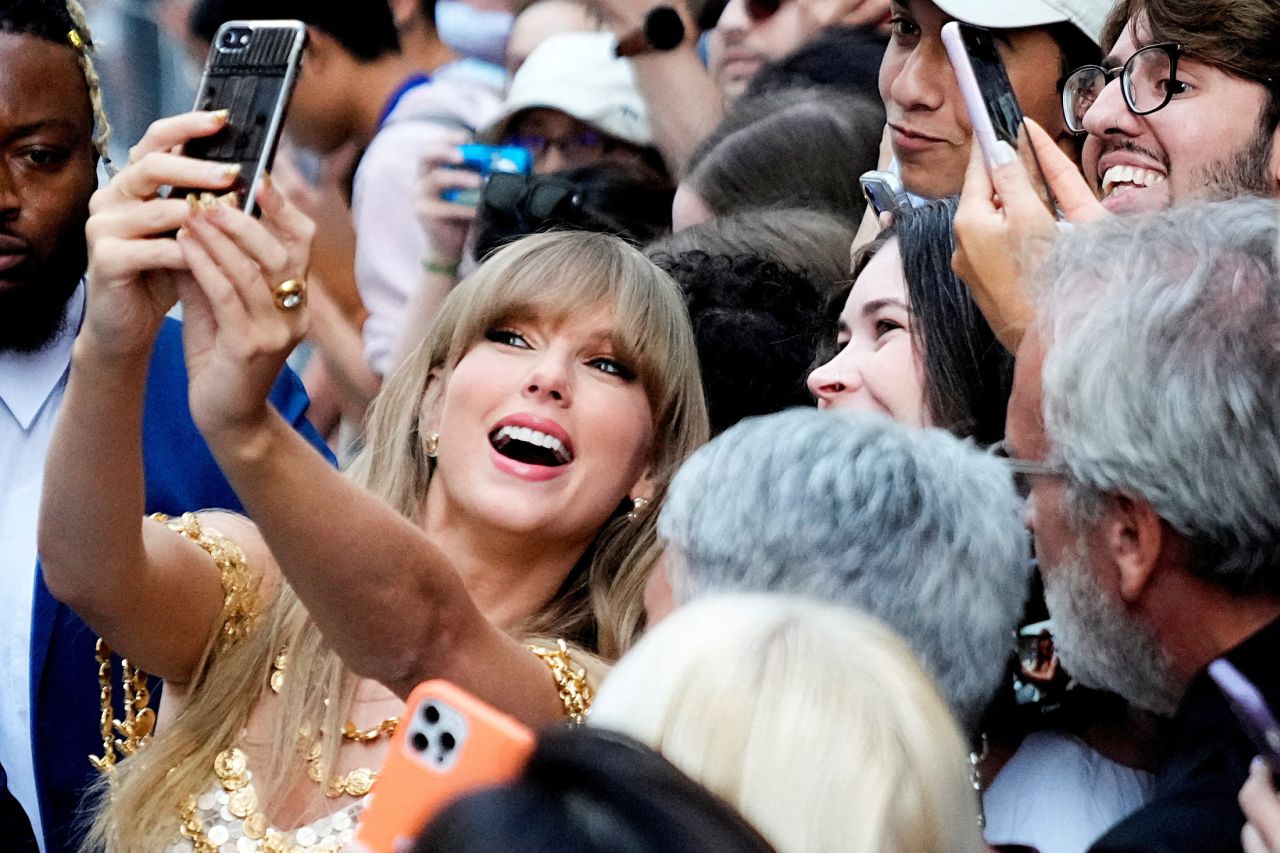 Singer Taylor Swift takes a selfie with fans as she arrives at the Toronto International Film Festival on Friday, September 9.