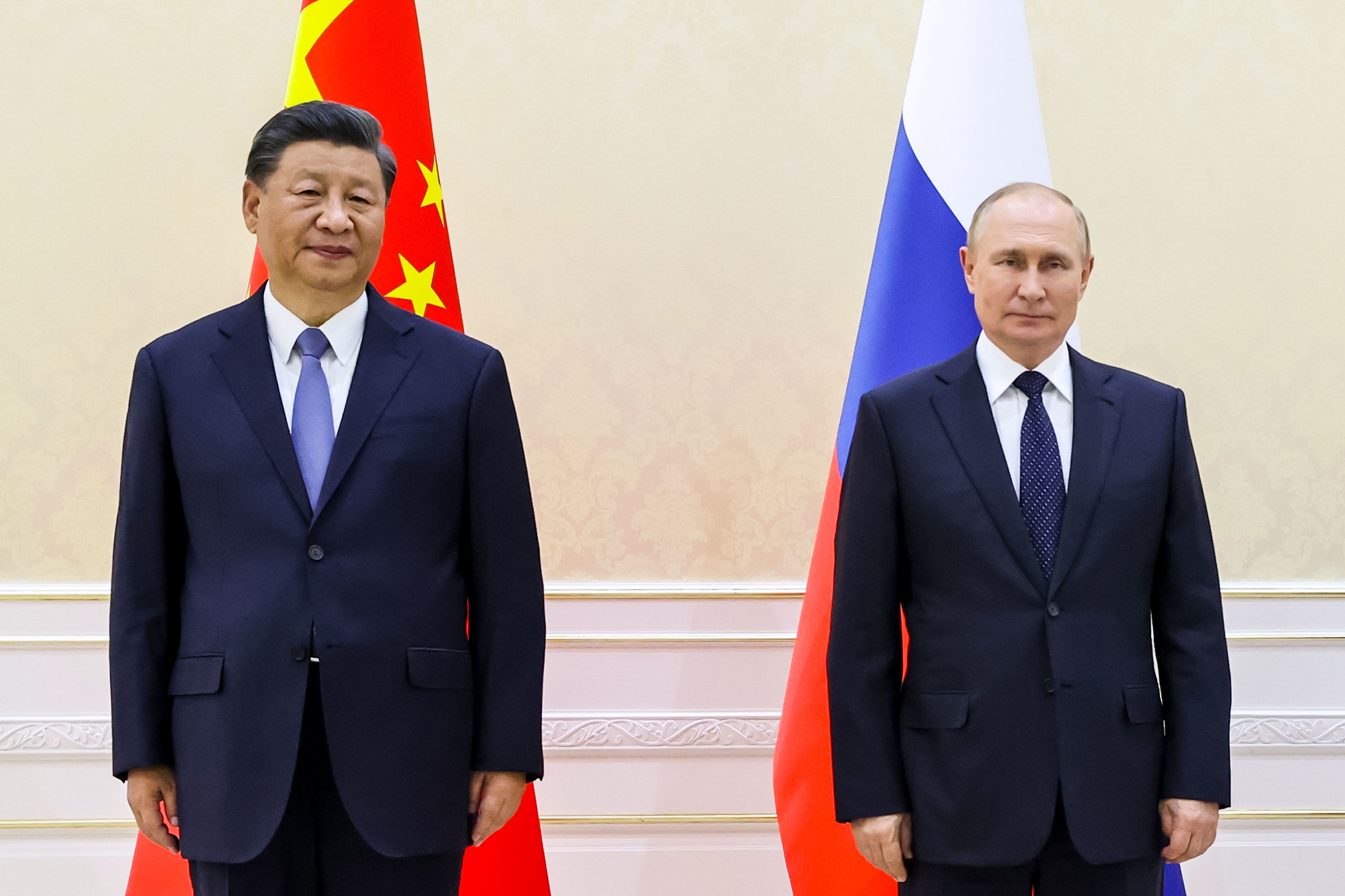 Chinese President Xi Jinping, left, and Russian President Vladimir Putin pose for a photo as they meet on the sidelines of a regional summit in Samarkand, Uzbekistan, on Thursday, September 15.