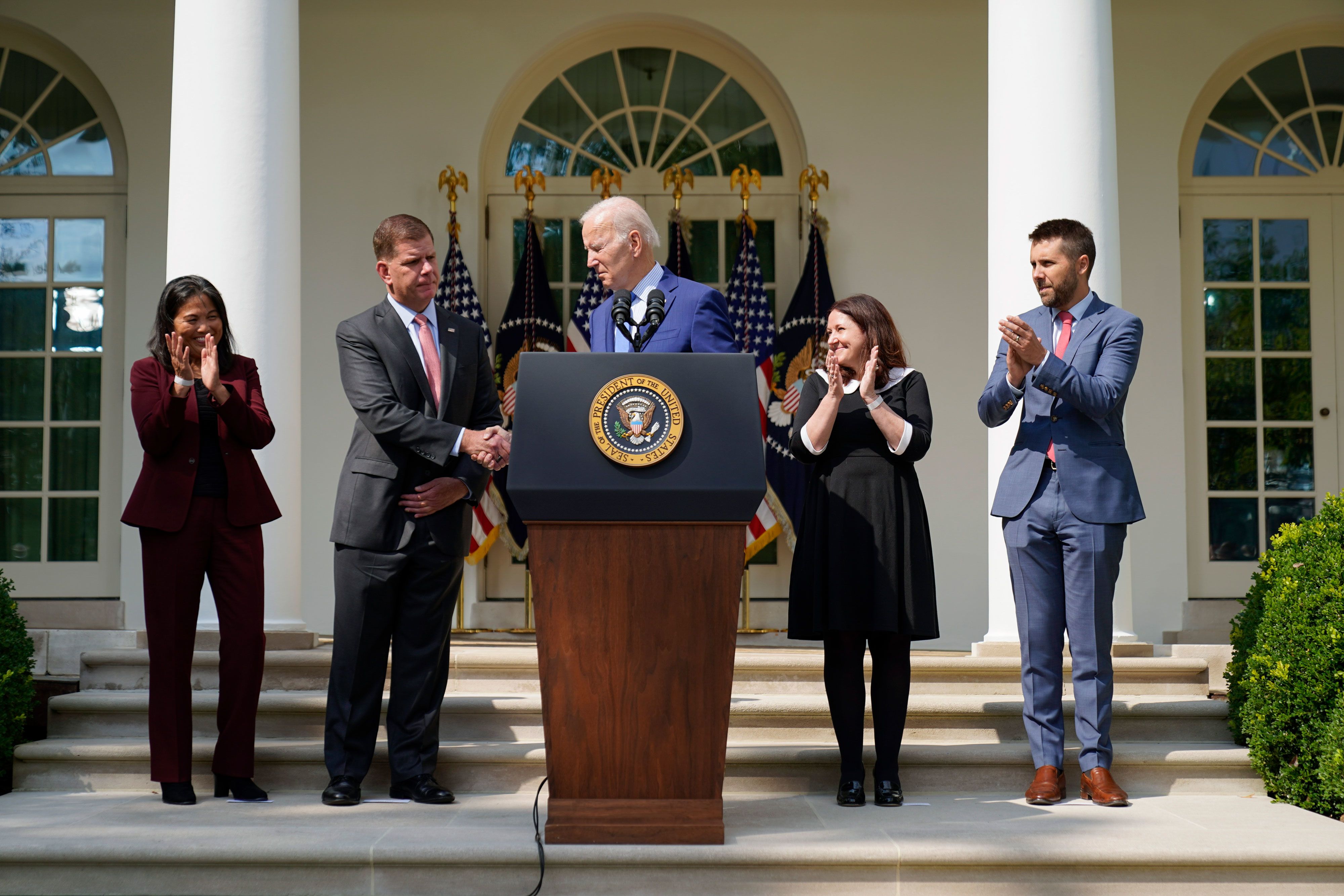 US President Joe Biden shakes hands with Labor Secretary Marty Walsh while speaking in the White House Rose Garden on Thursday, September 15.