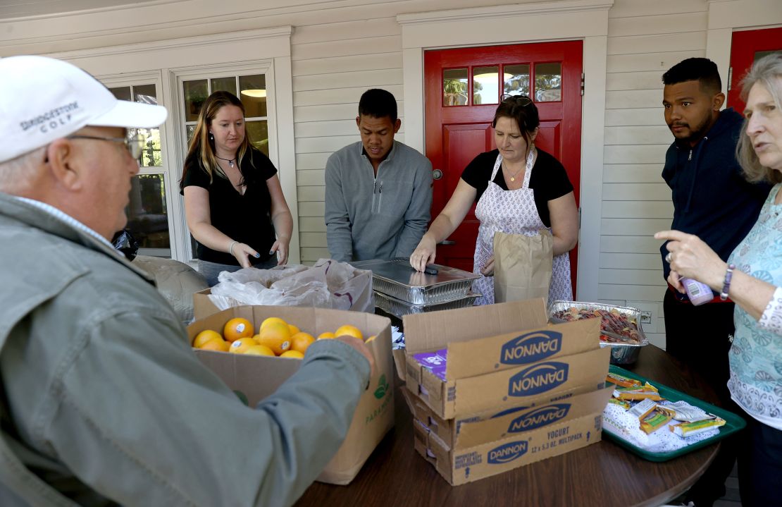 Volunteers help serve food to the recently arrived migrants.