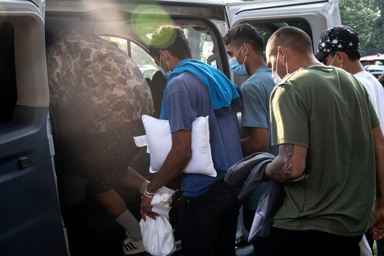 Migrants wait to be transported to a local church after buses dropped them off at the US Naval Observatory in Washington, DC, on Thursday, September 15. Texas Gov. Greg Abbott says <a href=