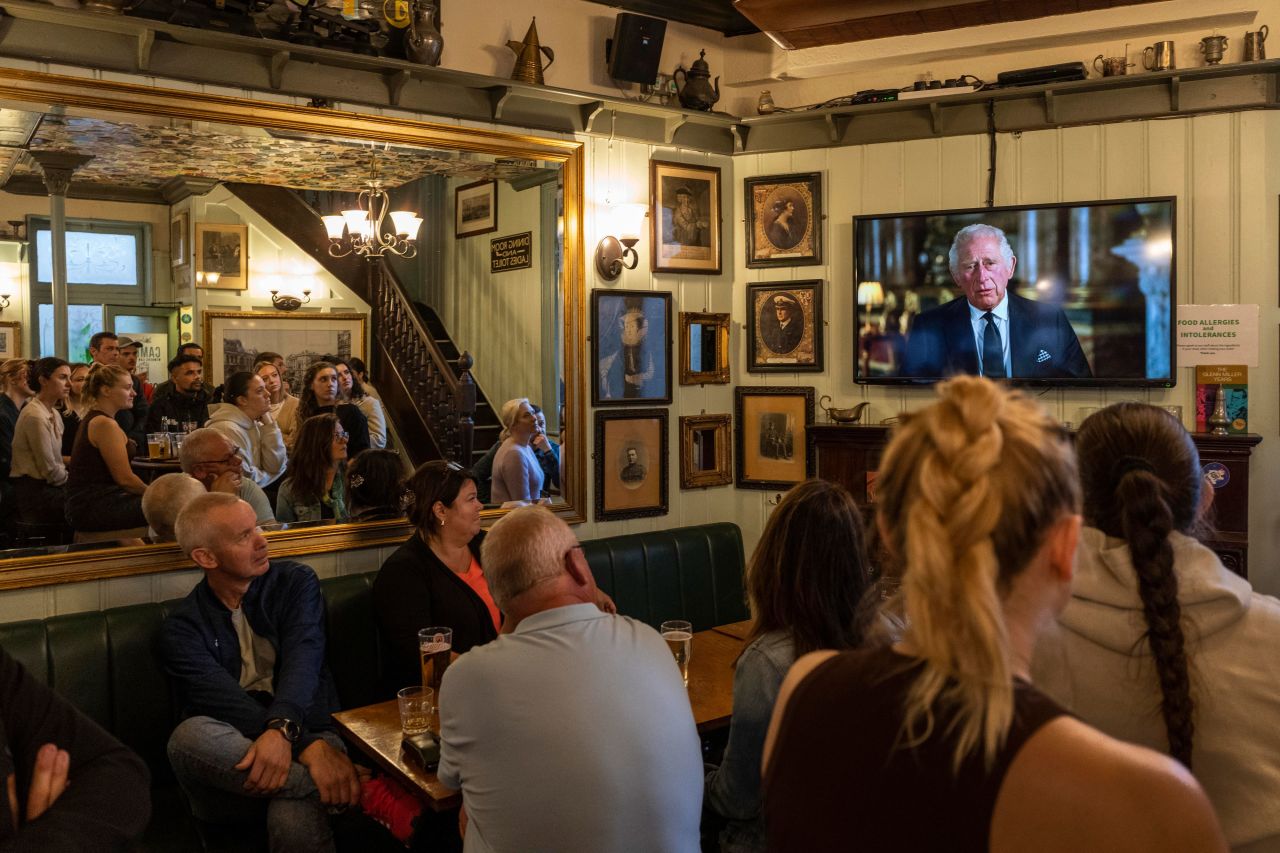 People inside a London pub watch a televised speech by King Charles III on Friday, September 9. "As the Queen herself did with such unswerving devotion, I too now solemnly pledge myself, throughout the remaining time God grants me, to uphold the Constitutional principles at the heart of our nation," he said.